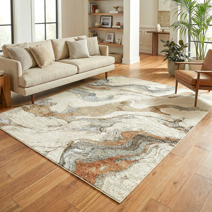 Living room with a patterned rug, beige sofa, and wooden floor.