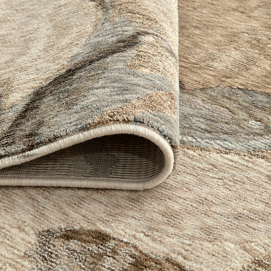 Close-up of a textured area rug with neutral colors