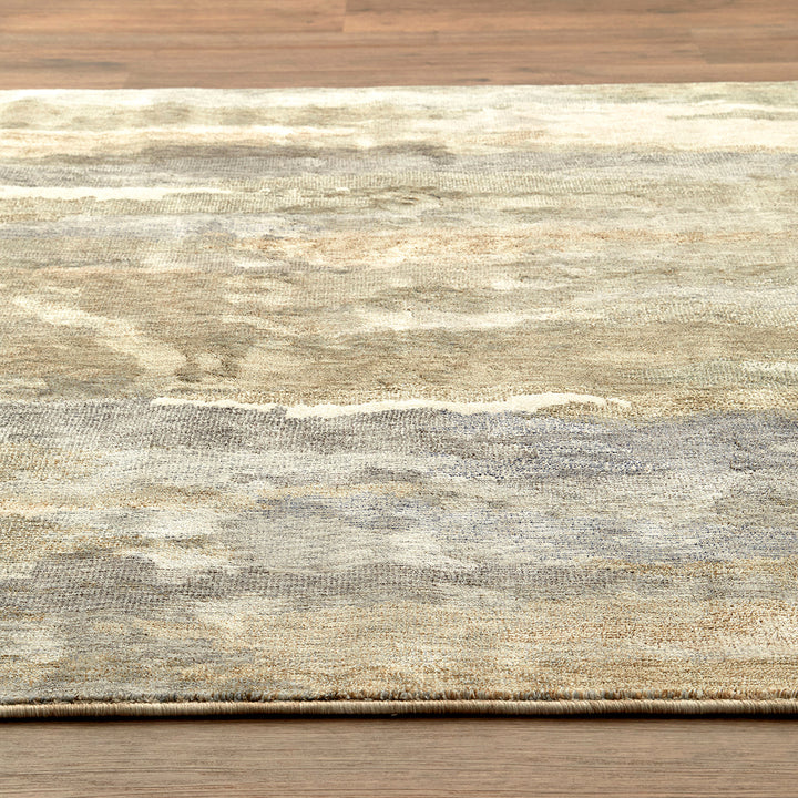 Textured rug with a neutral color palette on a wooden floor.