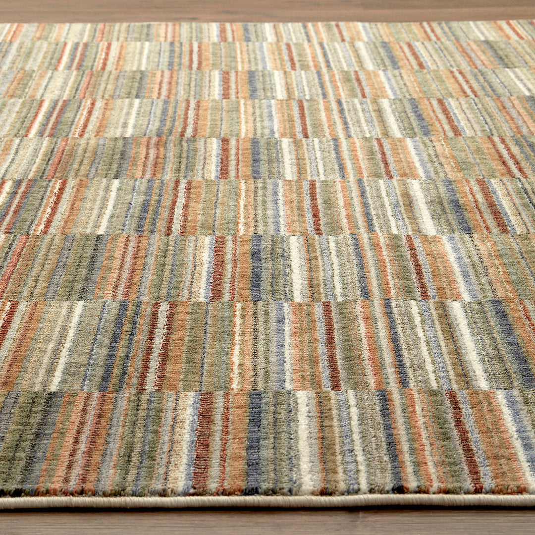 Multicolored striped rug on a wooden floor