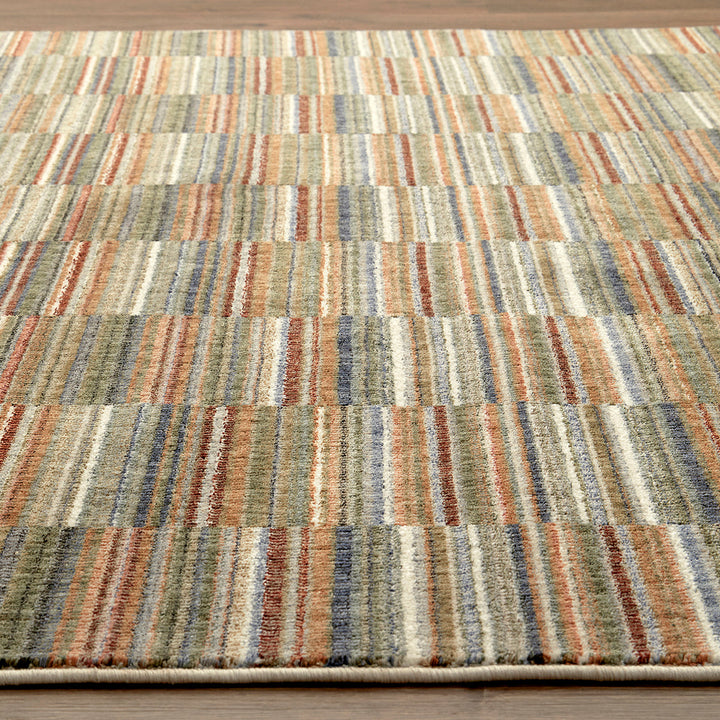 Multicolored striped rug on a wooden floor