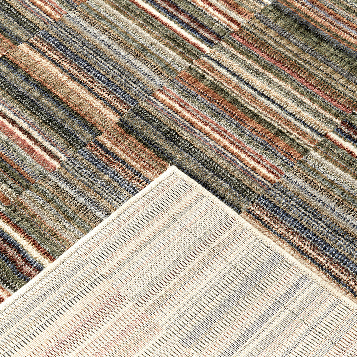 Close-up of a multicolored striped rug with a geometric pattern.