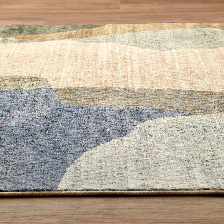 Multicolored abstract patterned rug on a wooden floor