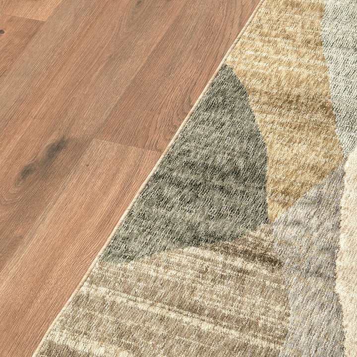 Edge of a multi coloured rug on floor boards
