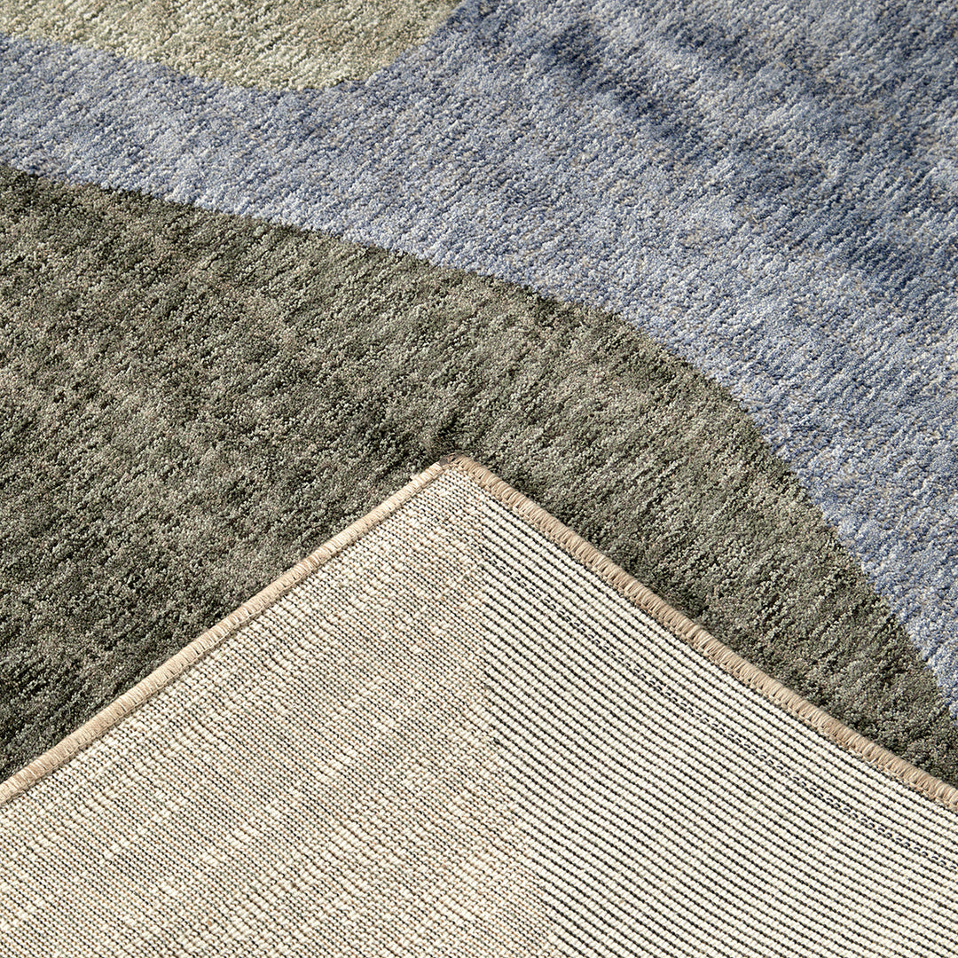 closeup of a multi coloured rug front and back cut pile