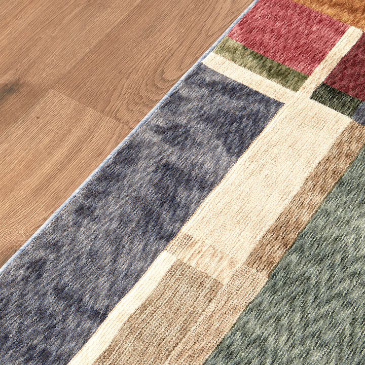 Multicolored area rug on a wooden floor