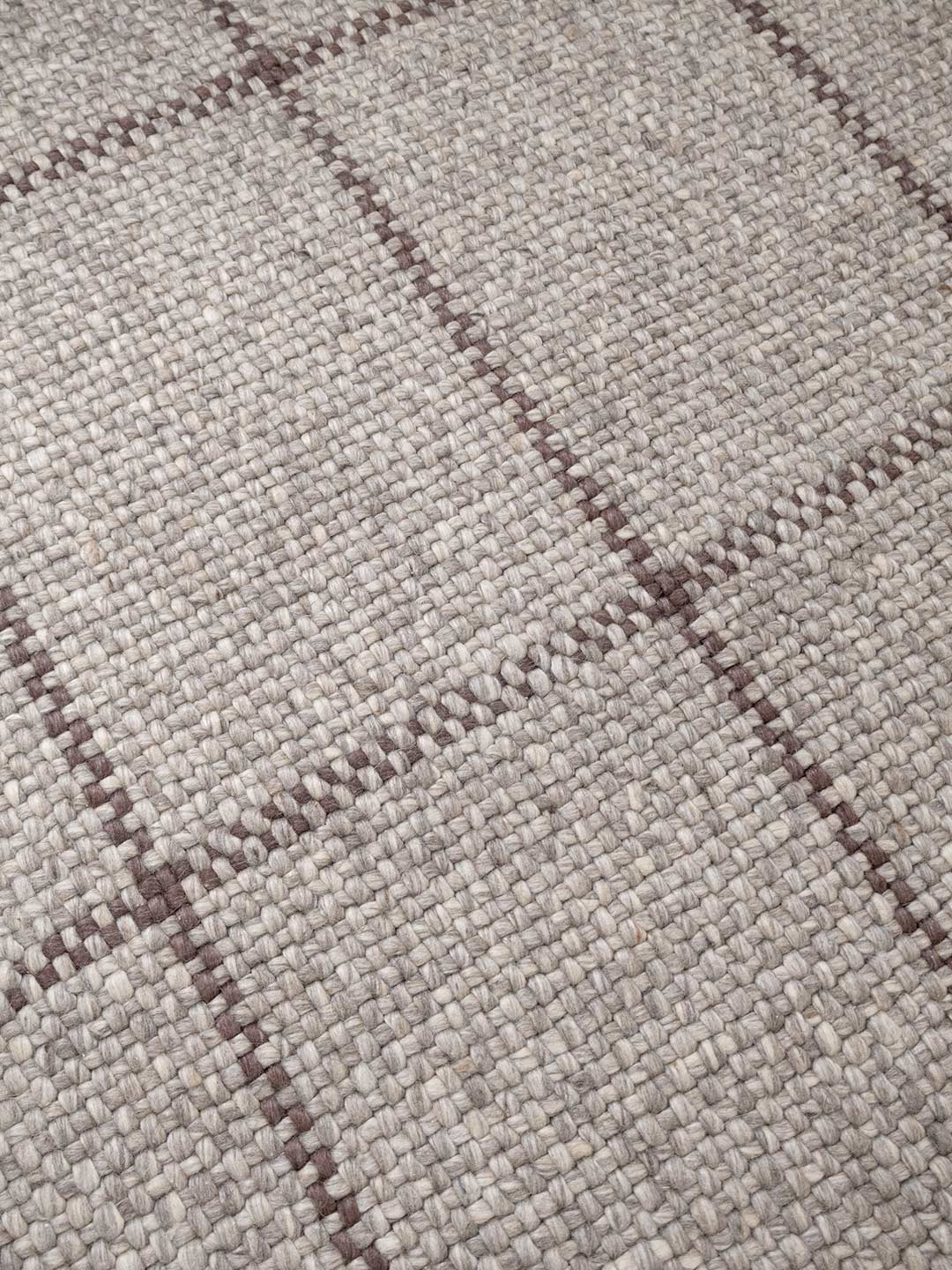 Close-up of a textured fabric with a checkered pattern in gray and brown.