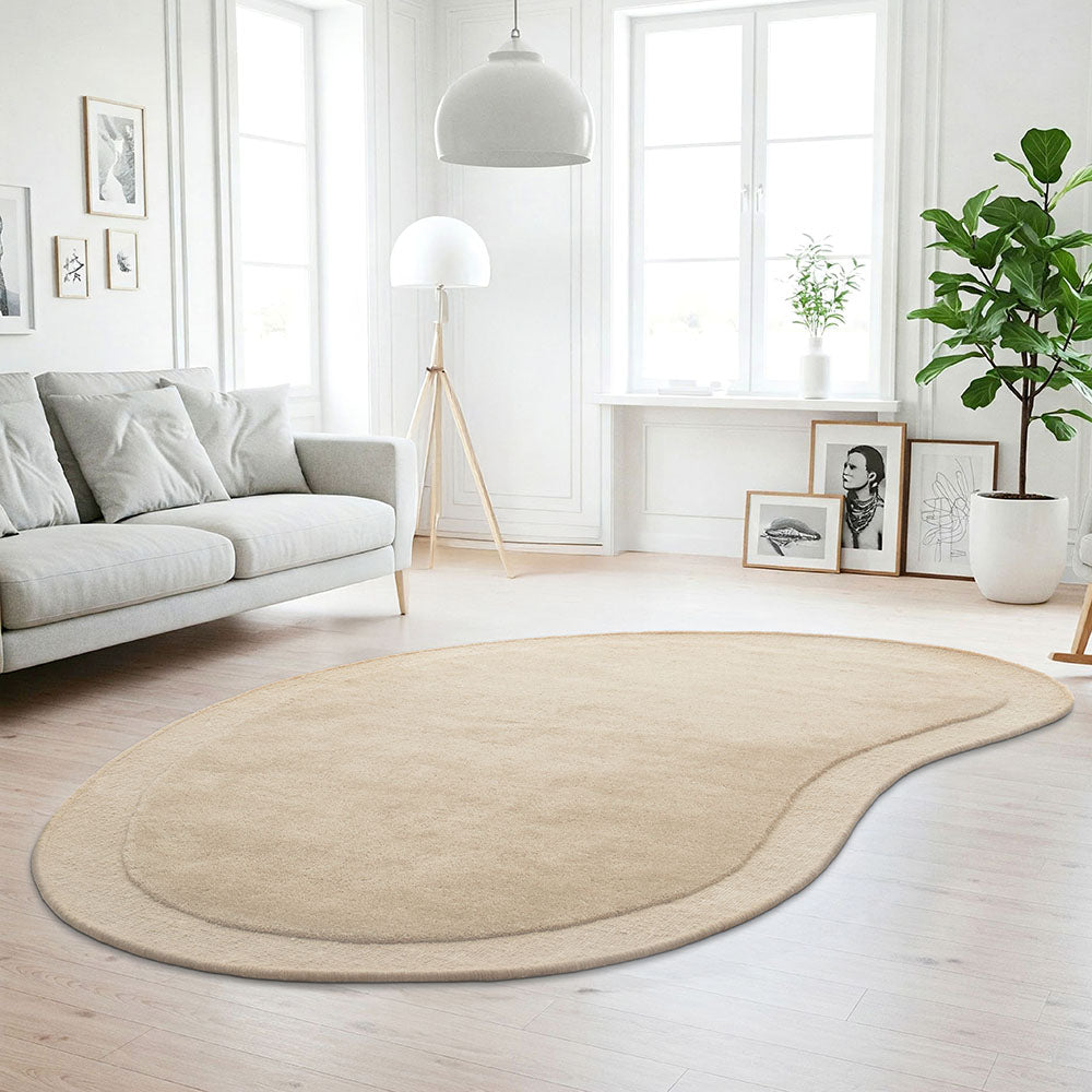 Beige rug on a wooden floor in a modern living room with a sofa and decor.
