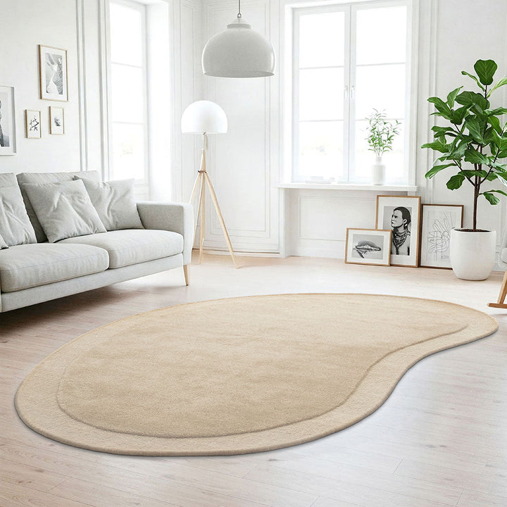 Beige rug on a wooden floor in a modern living room with a sofa and decor.