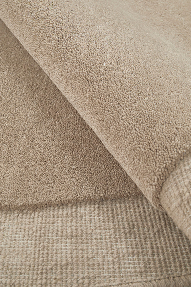 Close-up of beige textured fabric with different weave patterns