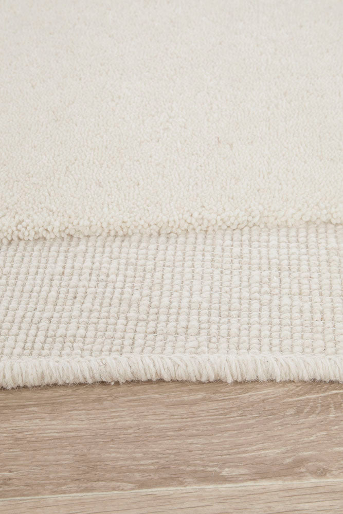 Close-up of a textured rug on a wooden floor