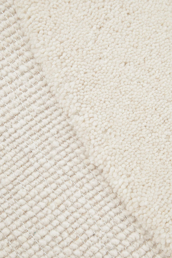 Close-up of a textured beige fabric with a subtle pattern