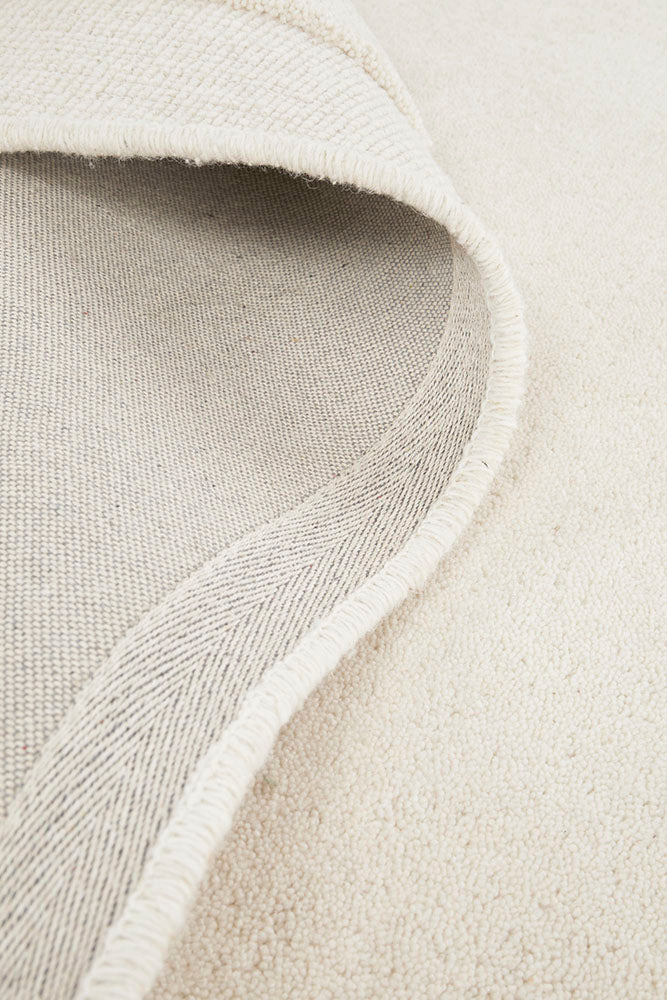 Close-up of a textured beige fabric with a subtle pattern