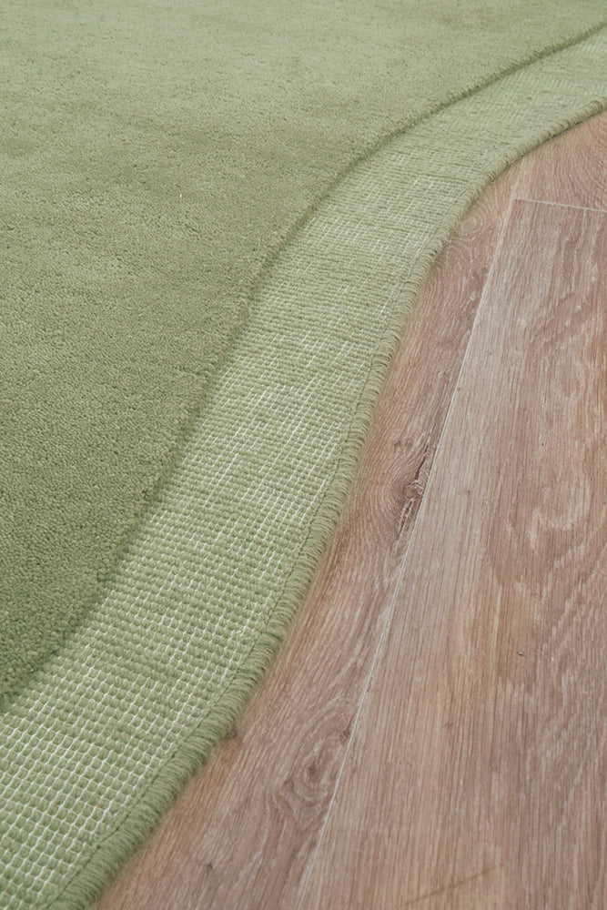 Transition from green textured fabric to wooden floor