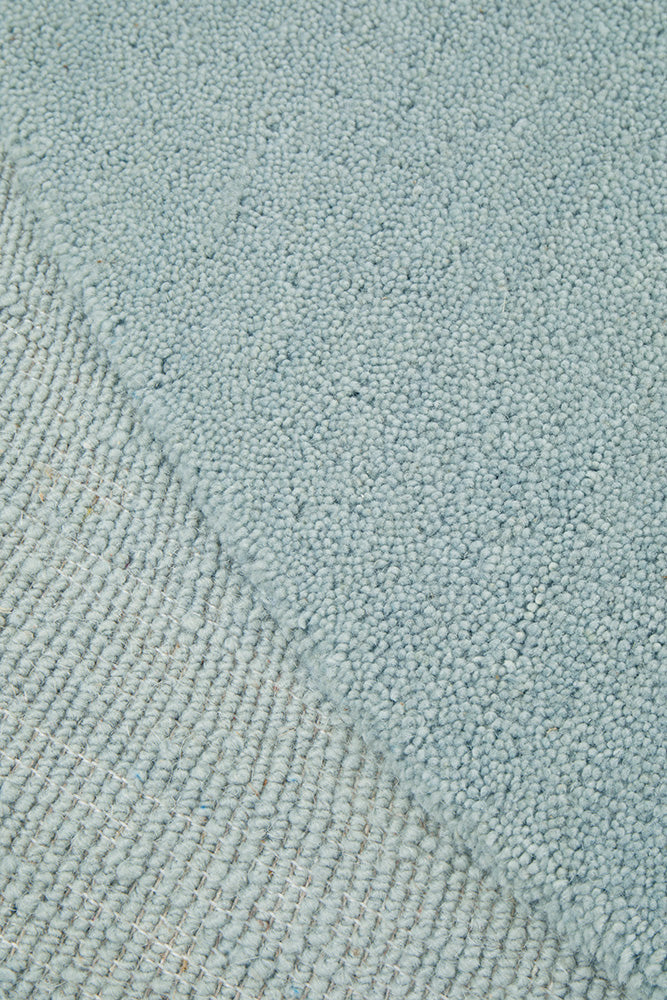 Close-up of a textured light blue fabric surface