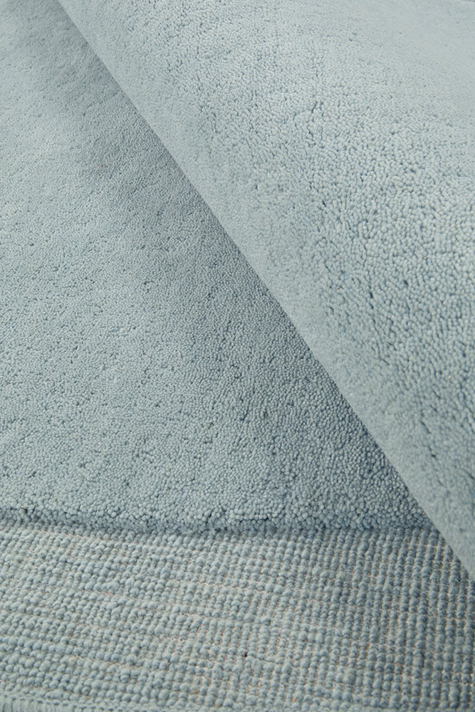 Close-up of textured light blue fabric with a subtle pattern