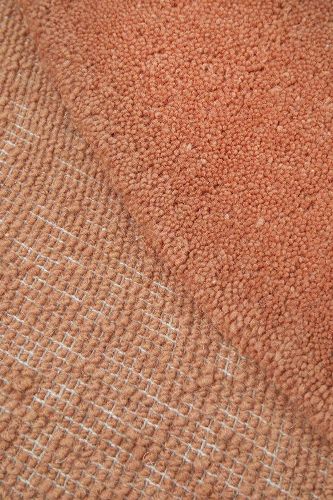 Close-up of a textured brown fabric with a subtle pattern