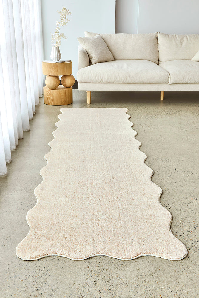 Wave edge hall runner on a concrete floor with a cream couch