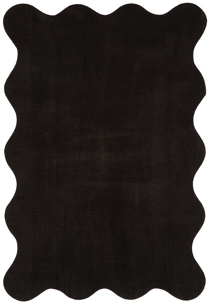 Black scalloped rug on a white background
