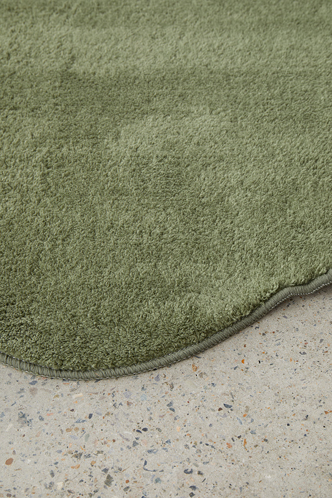 Green rug on a concrete floor