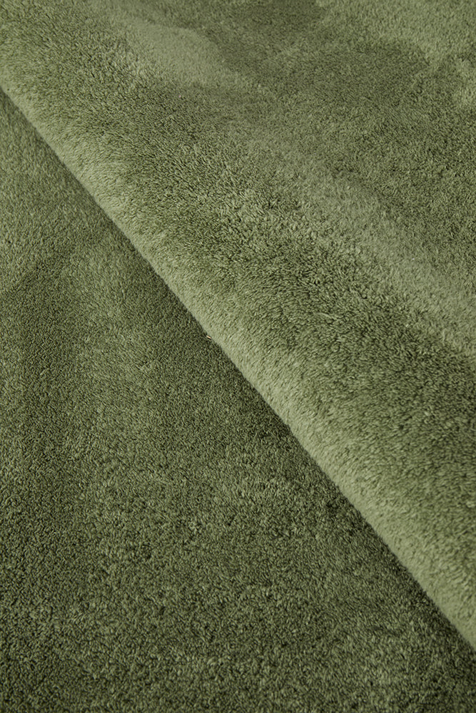 Close-up of green fabric with a textured pattern