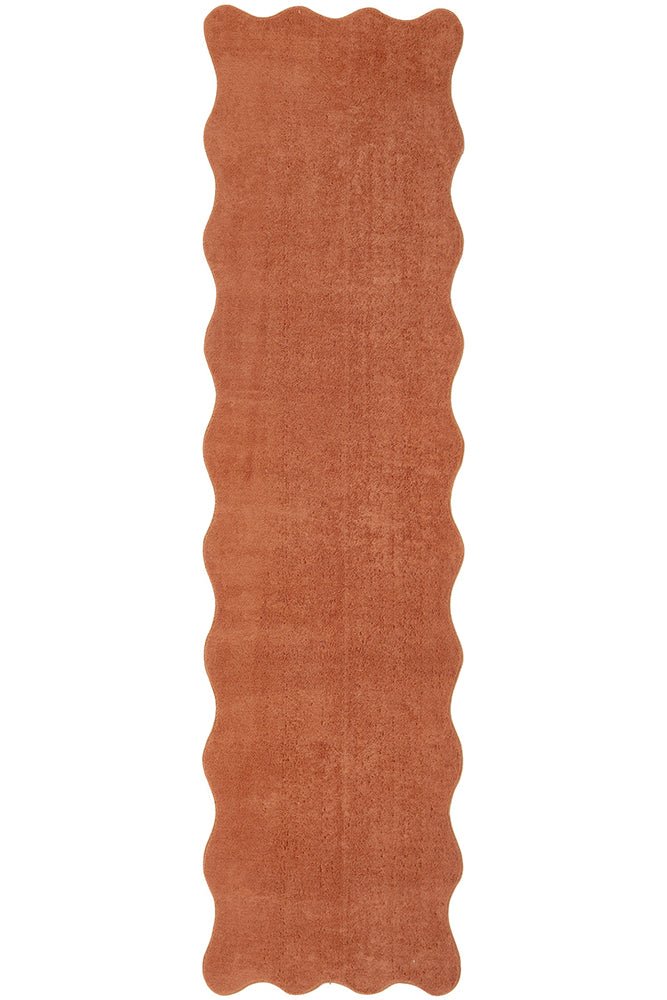 Rust-colored textured rug on a white background