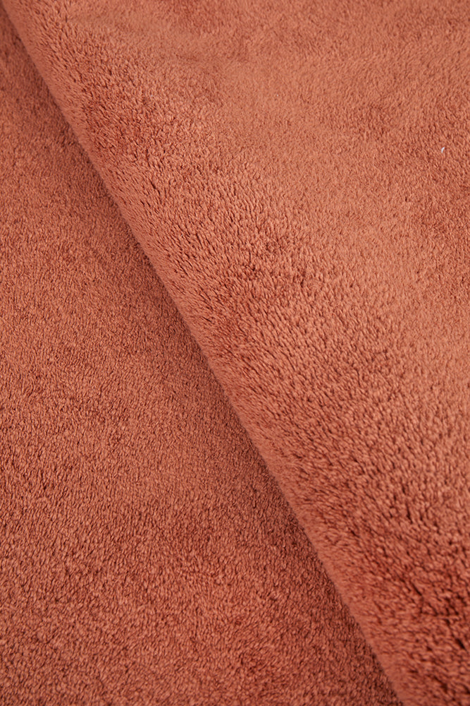 Close-up of rust textured fabric runner