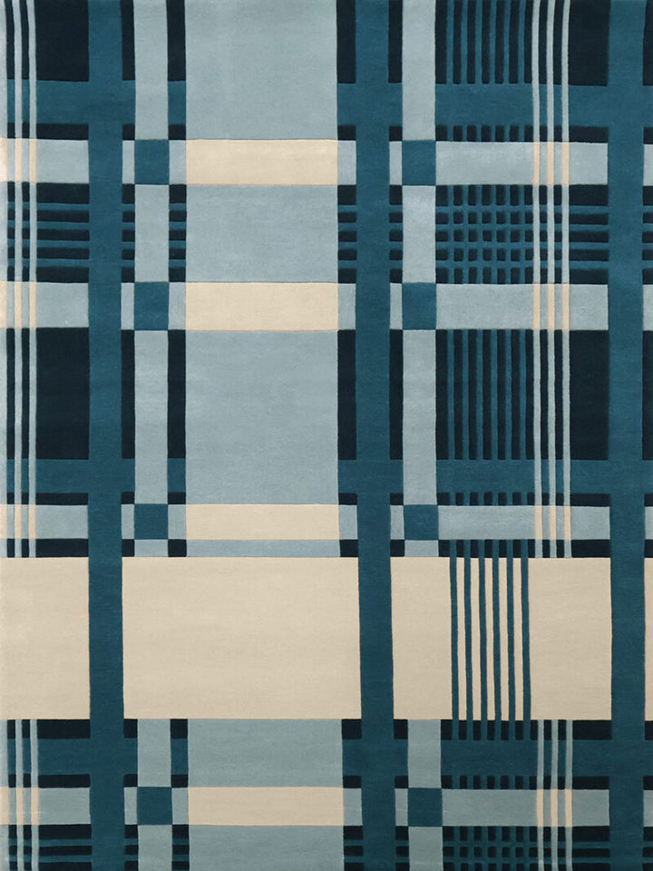 A square area rug featuring a modern geometric plaid pattern in shades of teal, navy, light blue, and cream.