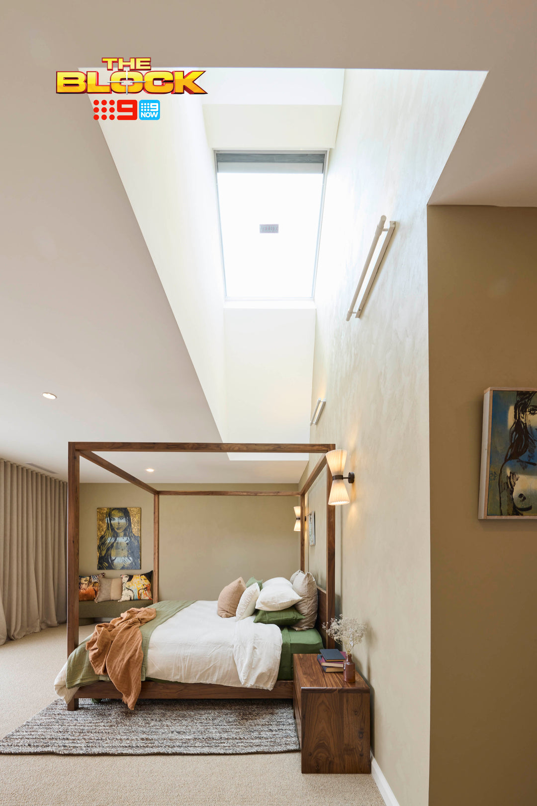 Modern bedroom with a skylight, bed, and decor elements. The Block