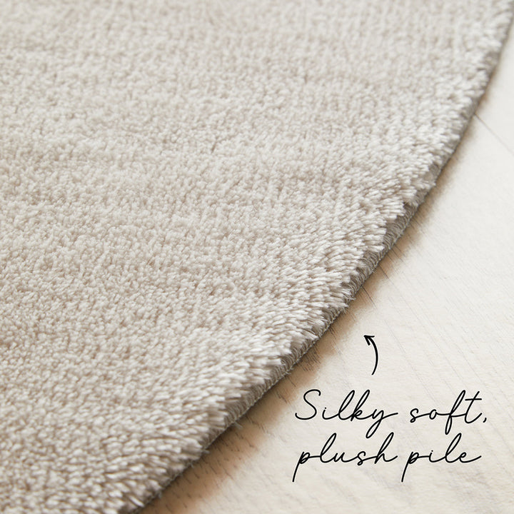 Close-up of beige carpet with 'Silky soft, plush pile' text