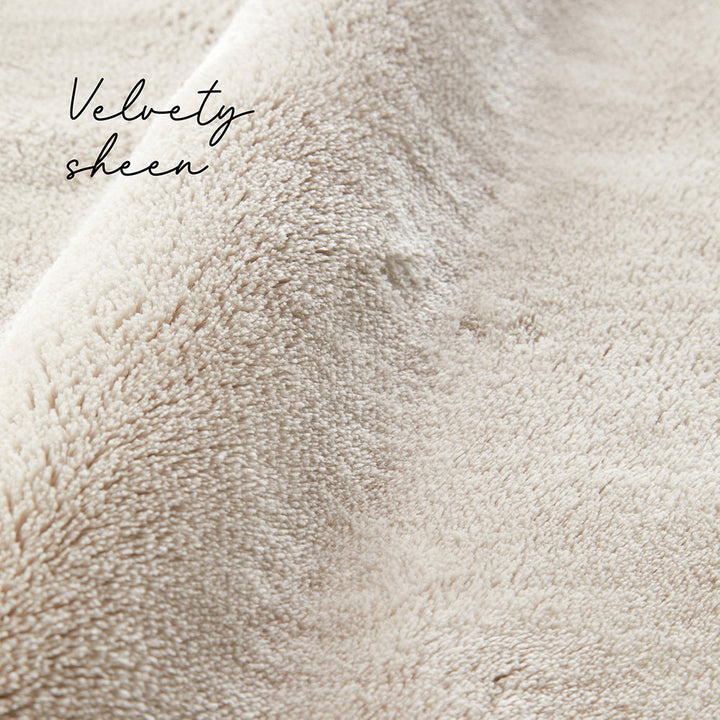 Close-up of beige fabric with 'Velvety sheen' text