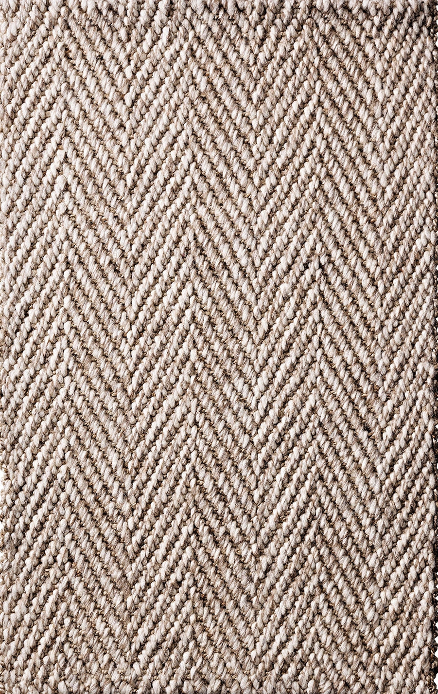 Textured rug with a herringbone pattern in beige and brown tones.