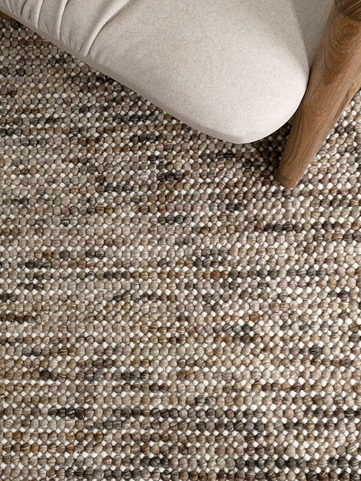 close up of a handmade wool textured rug in browns