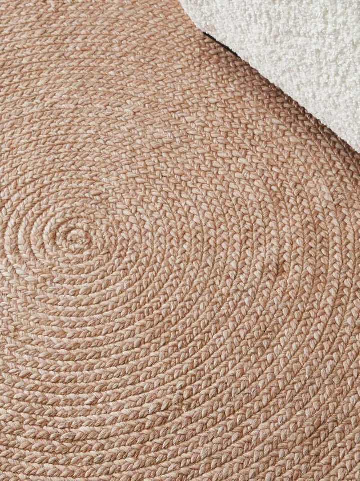 Close-up of a woven beige rug with a textured pattern