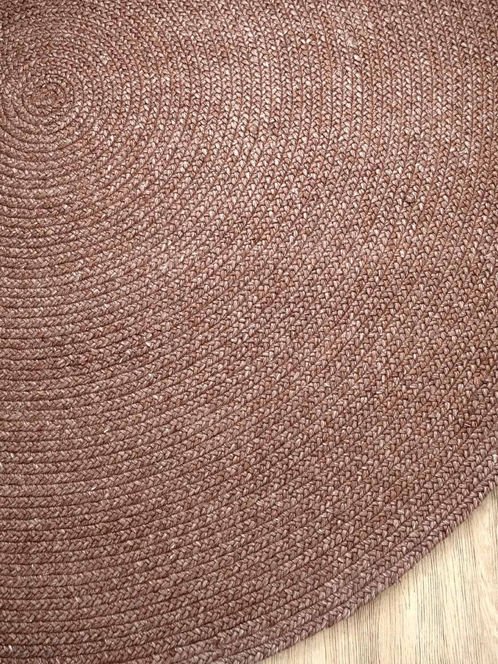 Close-up of a berry textured rug on a wooden floor