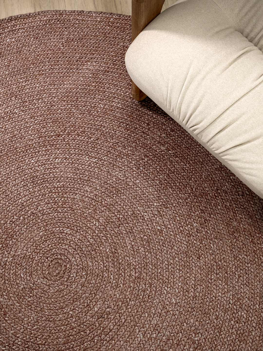 Berry pink textured carpet with a beige couch corner