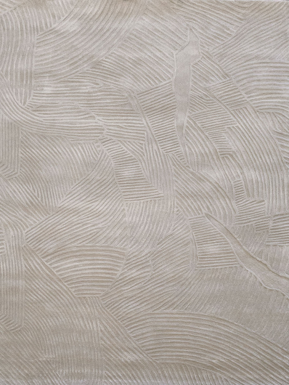 Beige textured fabric with a raised leaf pattern in a tonal cream color.