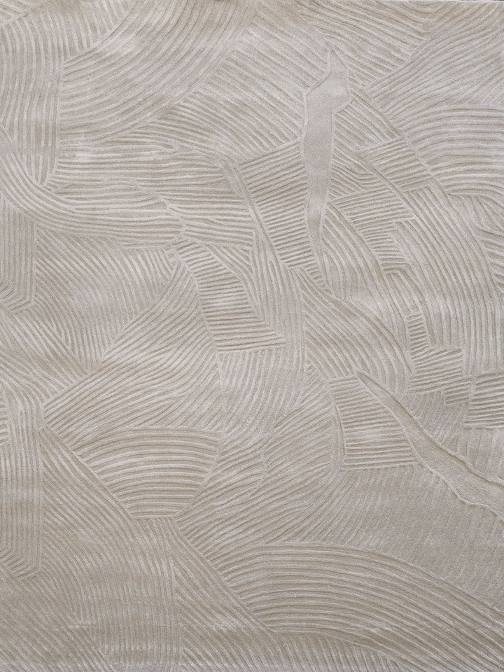 Beige textured fabric with a raised leaf pattern in a tonal cream color.