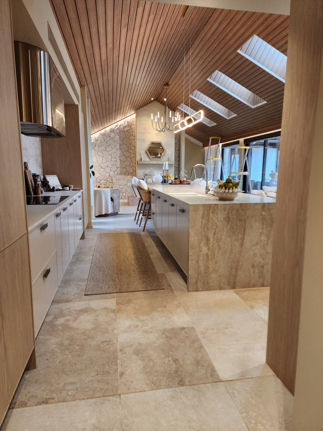 Modern interior design with wooden walls, marble floor, and ceiling lights. The Block 2025.