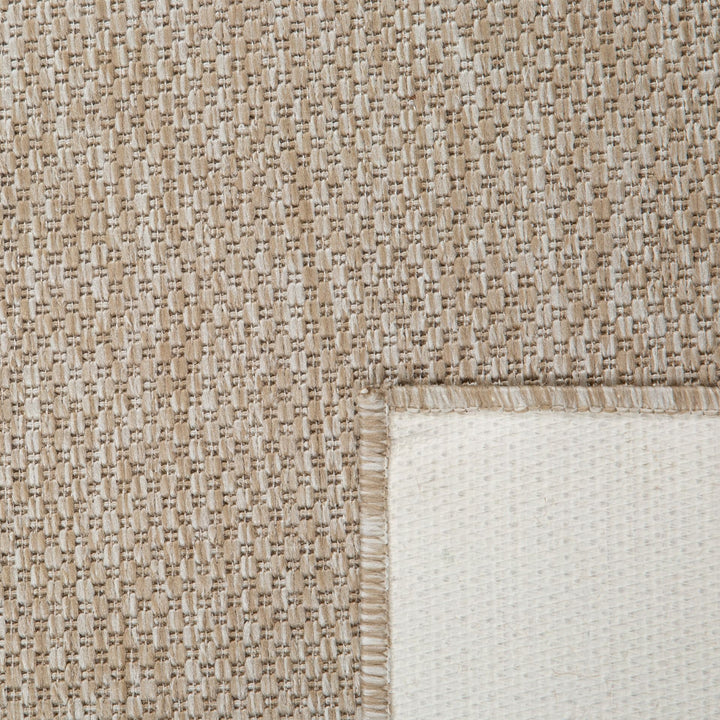 Close-up of a textured beige and white rug corner