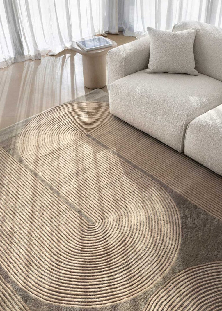 Modern living room with a circular patterned rug and a beige sofa.