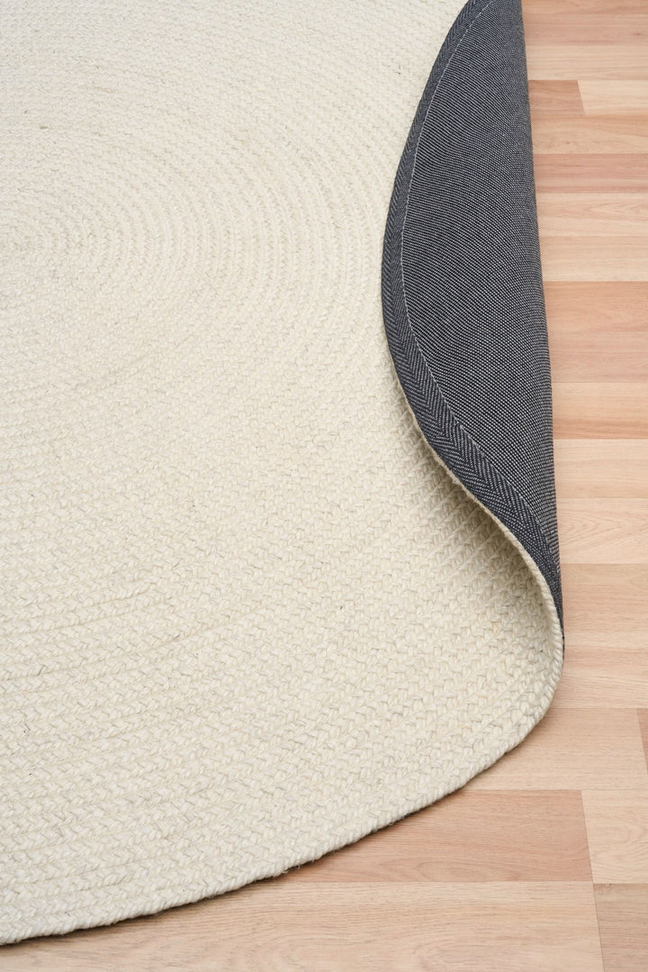 Beige rug with a textured pattern on a wooden floor