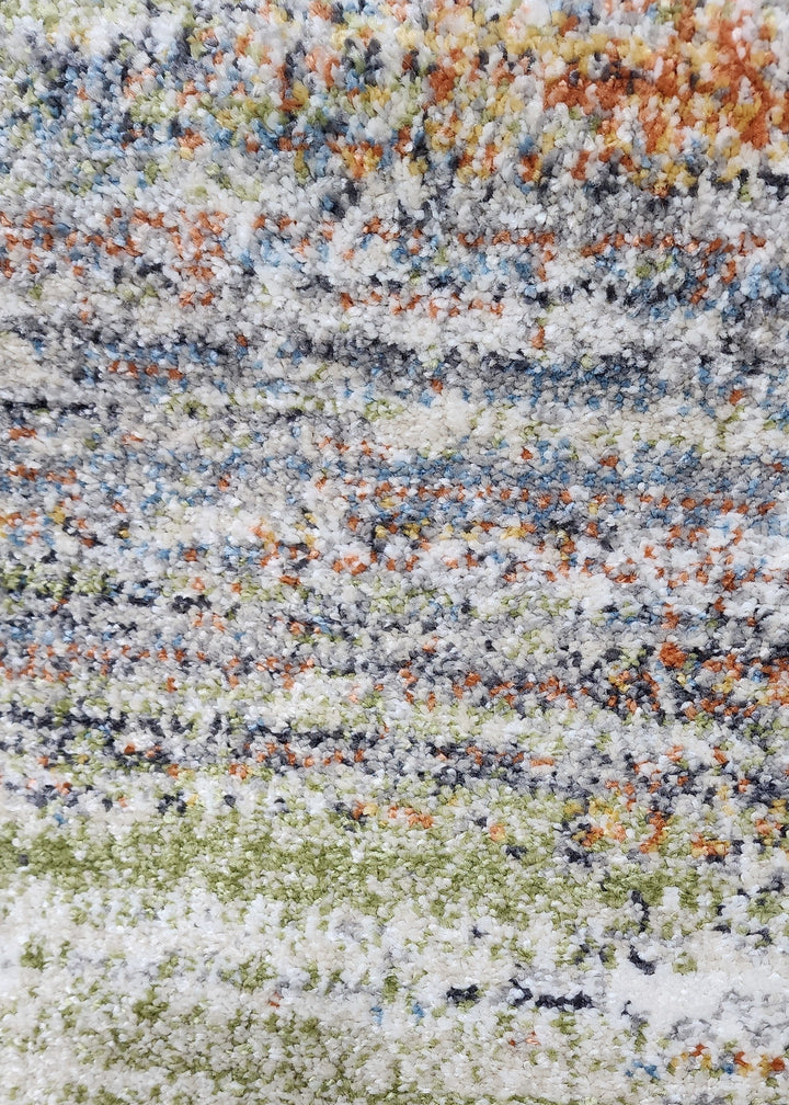 Multicolored striped pattern with shades of green, orange, and gray.