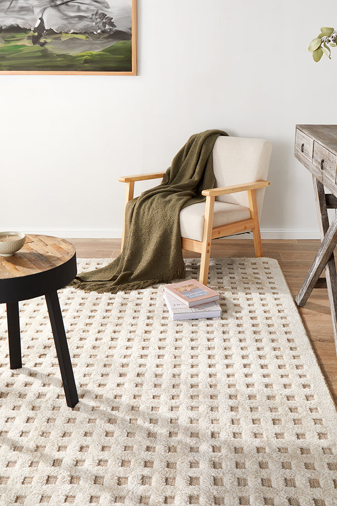 living room nook with a chair and a side table on a cream textured rug