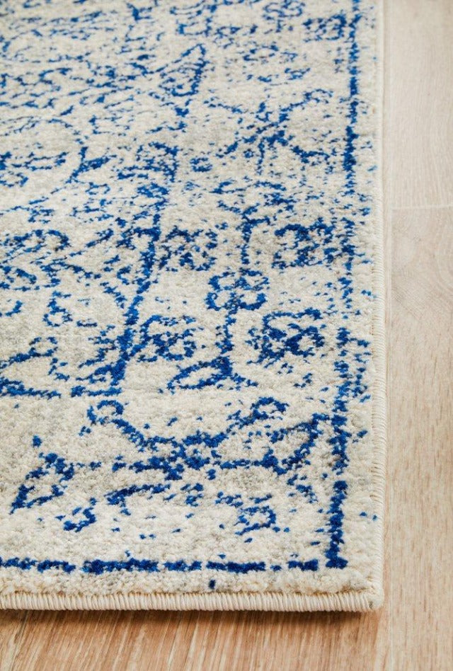 Evoke 258 White Rug with blue and grey highlights. Synthetic Machine Made Rug comes in Extra Large Sizes and Hall Runner