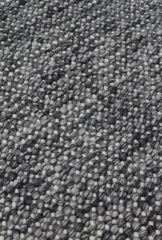 Magic Storm two tone greys and ivory blend handmade wool rug. knotted loops of wool adding texture finish